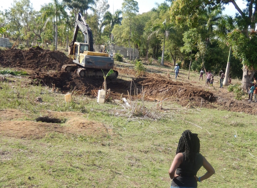 Regine Theodat observing construction for a tilapia farm in Savanne Perdue, a neighborhood of La Hoye, Haiti, October 2013.